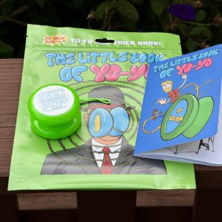 a photo of the Little Book Of Yo-Yo comic book. The photo also shows the transaxle yo-yo and the green plastic bag that everything comes in.