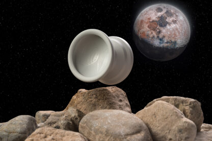A photo of the Moon Rock edition Shawn Exploder on the rocky surface of the moon. The yo-yo appears as if it is floating. Earth can be seen in the background.