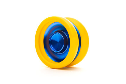 A slimline responsive yo-yo with metal hubs and plastic rims. The yo-yo is slim and has tall inner walls. It has fingerspin cups on the sides. This PLTPS is yellow plastic with blue aluminum hubs.