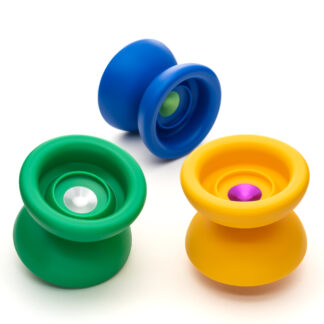 A photo of three different Desert Island Yos in different colors. Each one has a plastic body with a small aluminum hub and a nice fingerspin catch zone. The three different colors are blue plastic with green aluminum, green plastic with raw aluminum, and yellow plastic with pink aluminum.